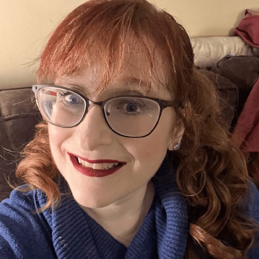 Selfie of a red-haired lady with glasses